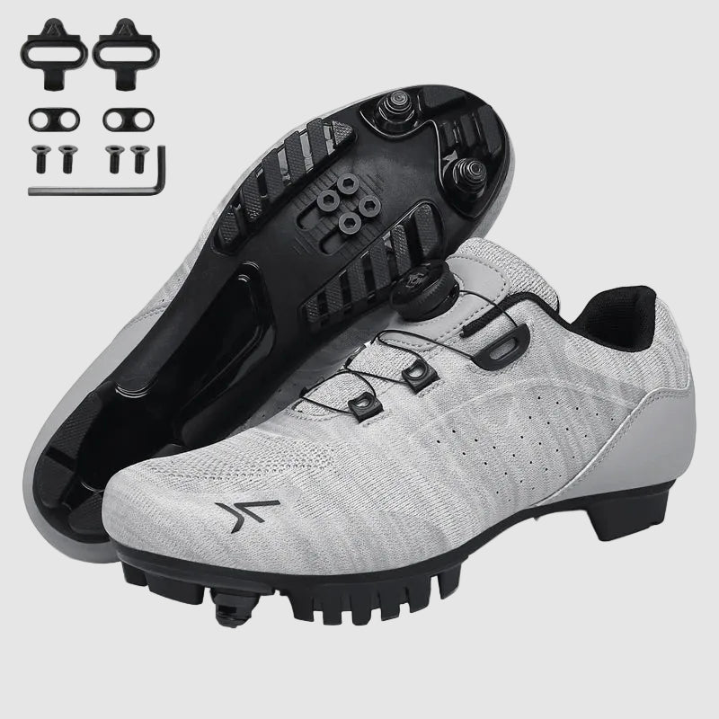 Gray cycling shoes with black cleats on a white background