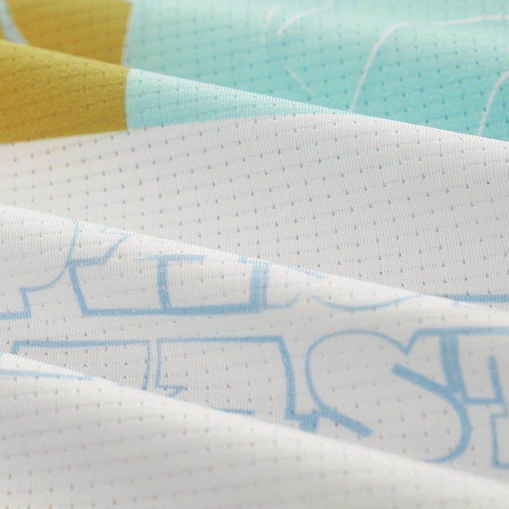 Close-up of a fabric with text and colorful patterns
