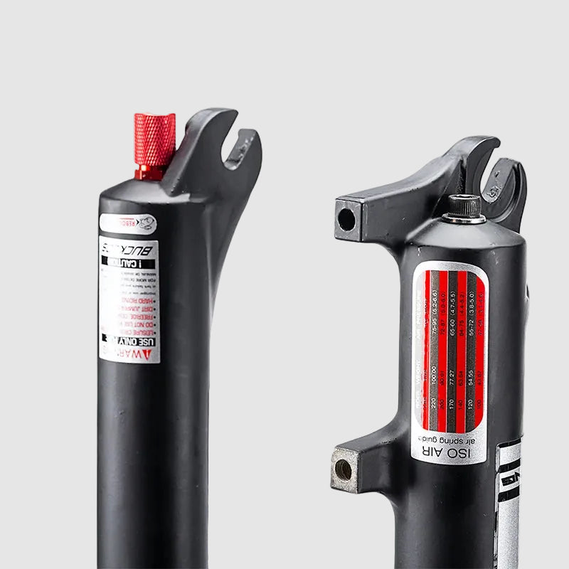 Two bicycle shock absorbers with visible branding on a white background