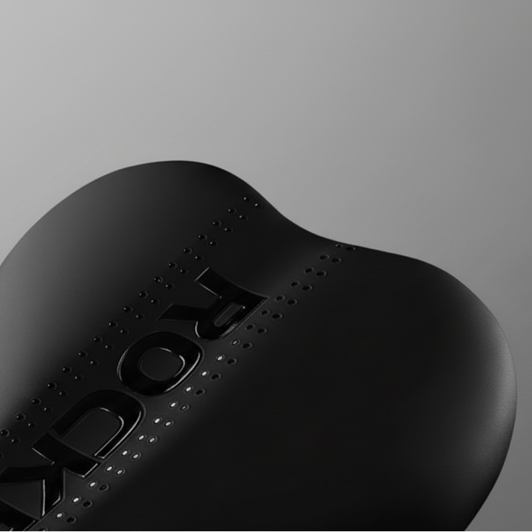 Close-up of a black electronic device with 'Xbox' branding on a gray background