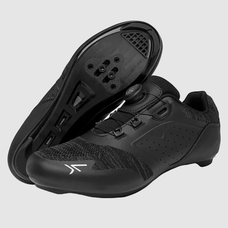 Black cycling shoes with cleats and straps on a white background