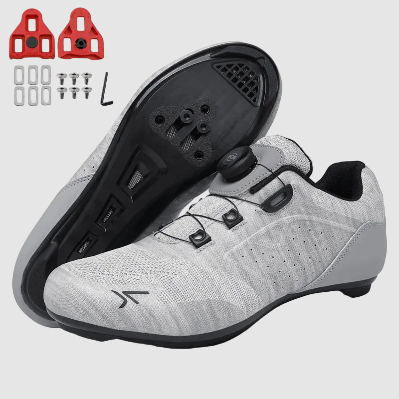 Gray cycling shoes with black soles and a small logo on a white background.