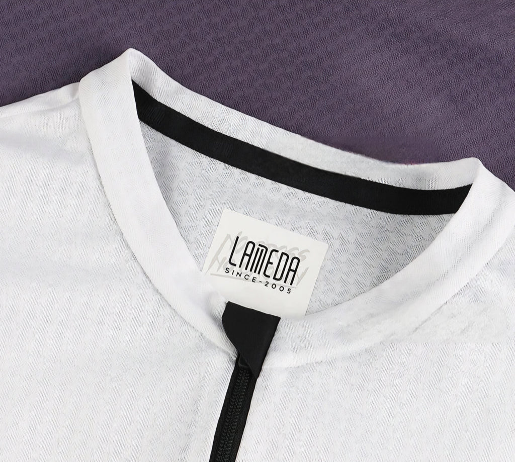 Close-up of a white garment with a Lameda label on a purple background