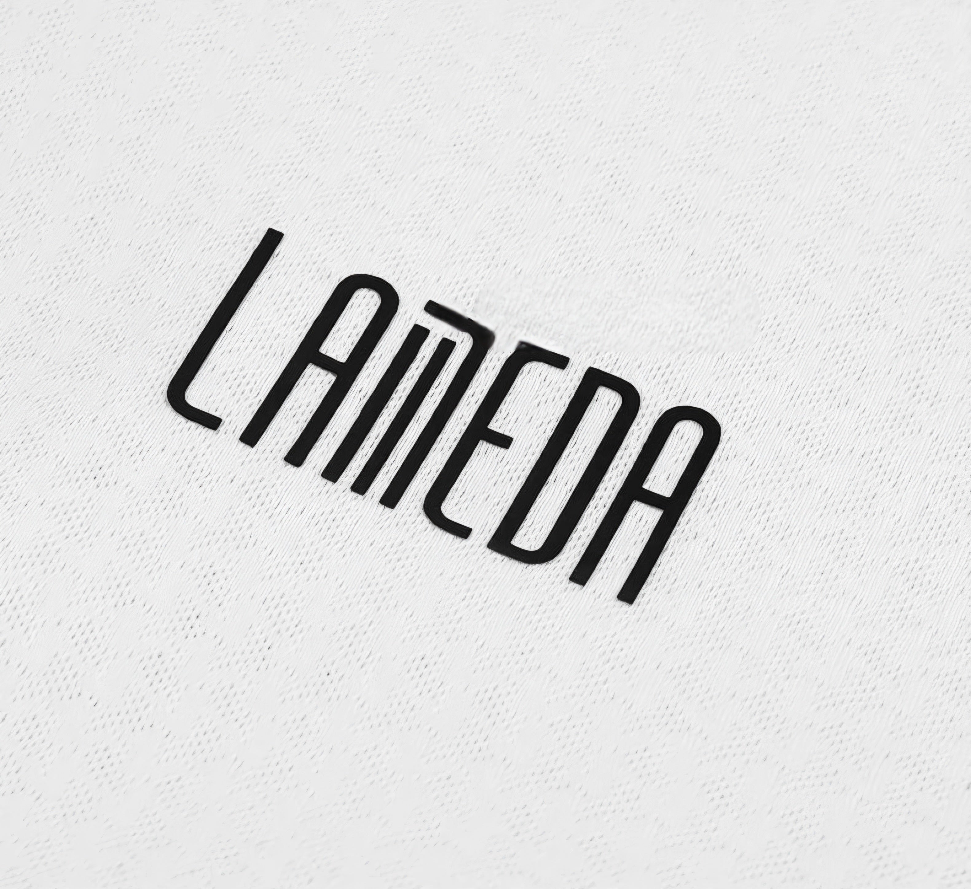 Black 'Lameda' logo on a textured white background