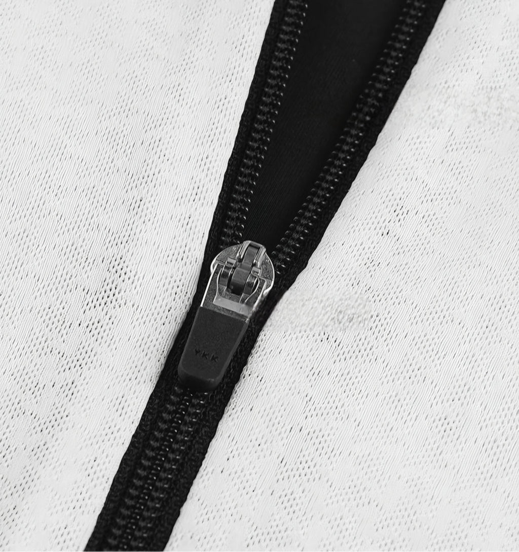 Close-up of a black zipper on a white fabric background